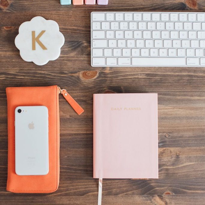 Keyboard, phone, daily planner and coaster with a K on it.
